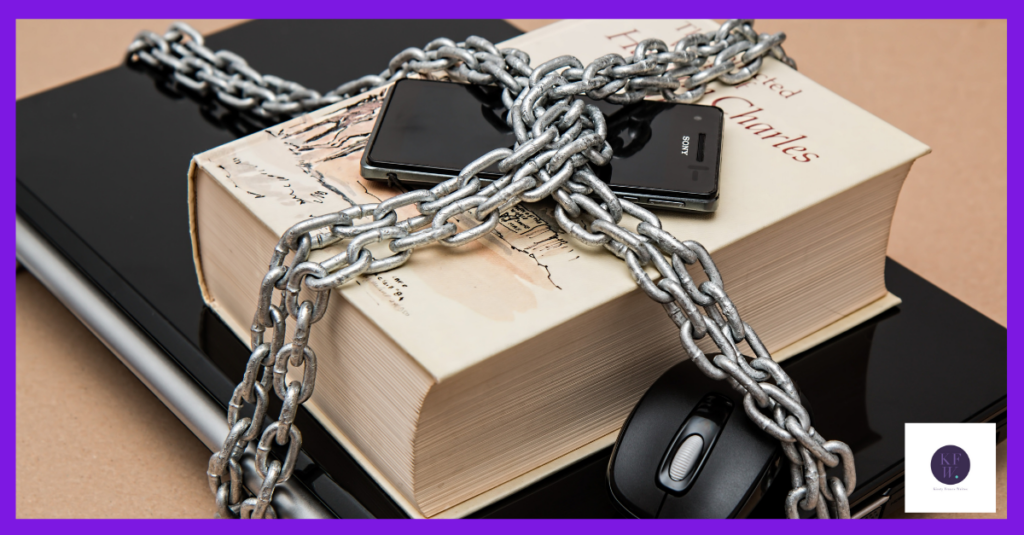 The image shows a laptop, book and phone wrapped in chains. This is setting boundaries at its least technical and most extreme.