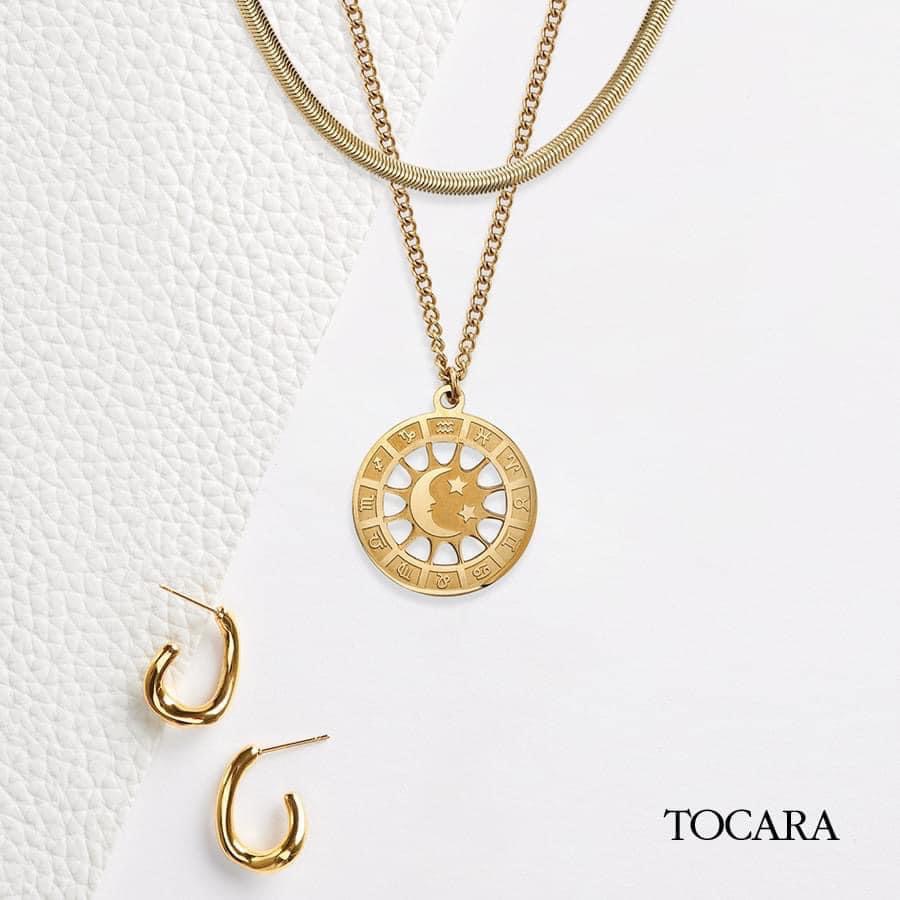 Image showing gold astrological necklace and earrings from Tocara, Sarah's jewellery business.